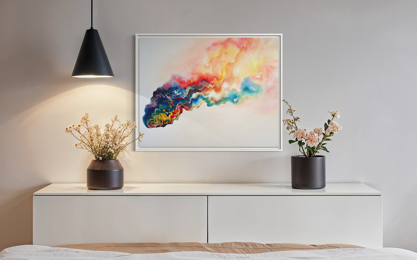 Modern interior with a colorful abstract painting on a wall above a white dresser with two potted plants.