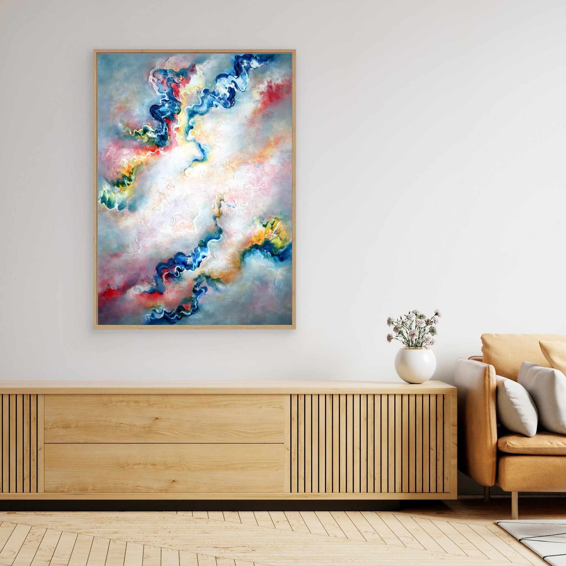 Large grey abstract art print on canvas framed in an oak float frame in a stylish living room setting