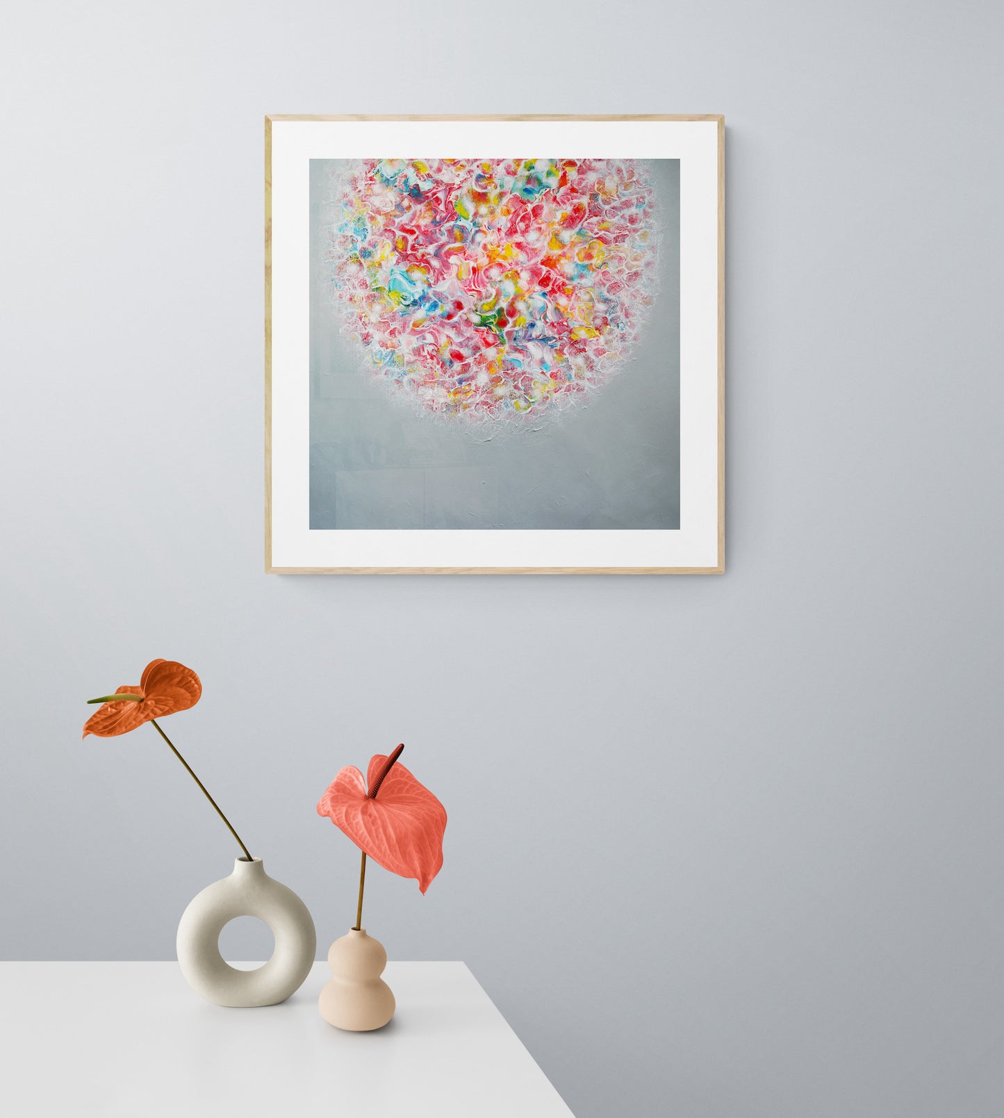A vibrant abstract artwork behind flowers